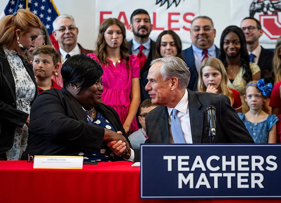 <em>JoMeka Gray</em> with Texas Gov. Greg Abbott (<em>Getty Images</em>)