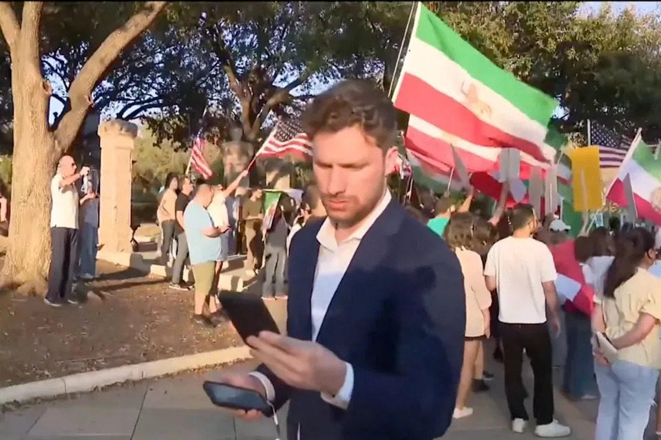 Vinny Martorano reads a message on his phone at the Texas Capitol rally — seconds before the moment that would go viral. (CBS Austin)