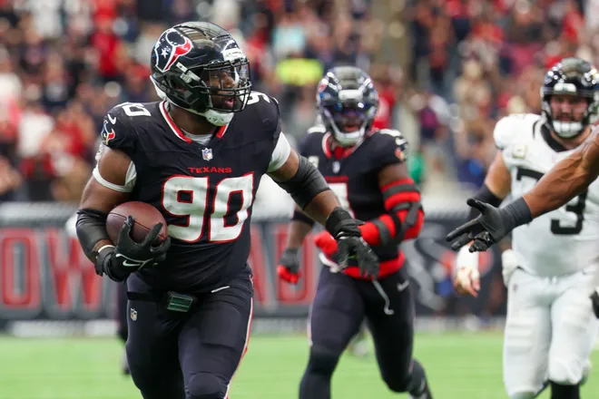 Nov 9, 2025; Houston, Texas, USA; Houston Texans defensive tackle Sheldon Rankins (90) runs for a touchdown after recovering a fumble by the Jacksonville Jaguars during the second half at NRG Stadium. Mandatory Credit: Thomas Shea-Imagn Images