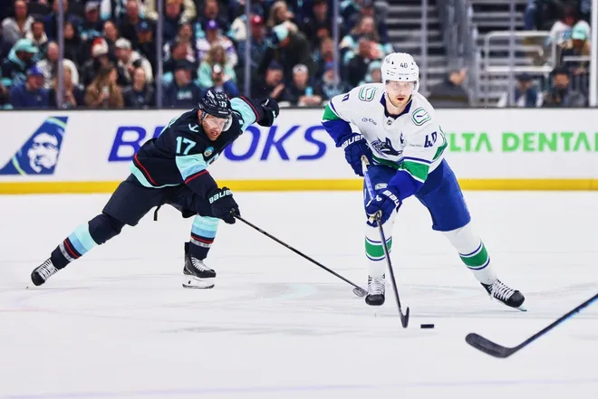 Feb 28, 2026; Seattle, Washington, USA; Vancouver Canucks center Elias Pettersson (40) looks to pass as Seattle Kraken left wing Jaden Schwartz (17) defends during the first period at Climate Pledge Arena.