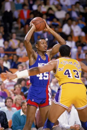 LOS ANGELES - 1988: Dallas Comegys #45 of the New Jersey Nets looks to pass the ball over Mychal Thompson #43 of the Los Angeles Lakers during the NBA game at the Great Western Forum in Los Angeles, California in 1988. NOTE TO USER: User expressly acknowledges and agrees that, by downloading and/or using this Photograph, User is consenting to the terms and conditions of the Getty Images License Agreement. Mandatory copyright notice : Copyright 1988 NBAE. (Photo by Mike Powell /Getty Images)