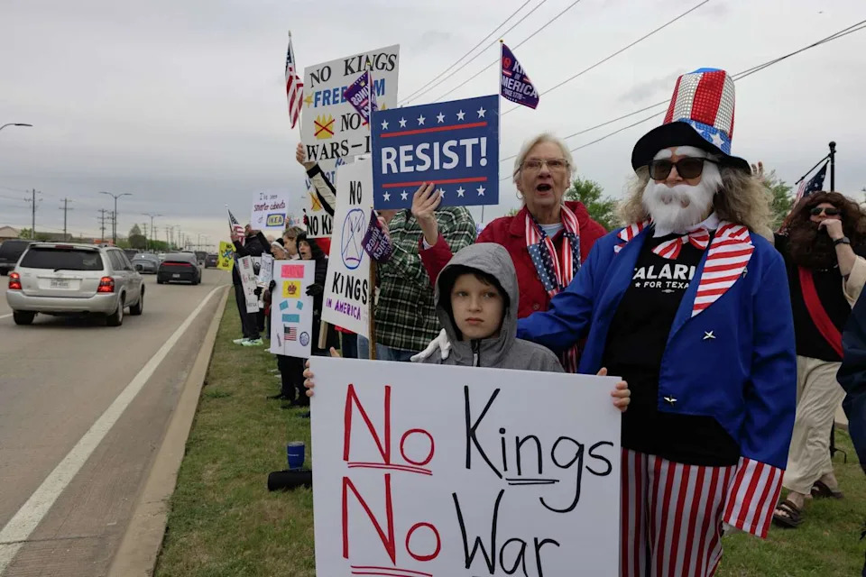 Keene Horvath and his grandmother, Necia Jackson-Guidry, dressed as Uncle Sam, hold signs and chant during a No Kings protest March 28, 2026 in Frisco. (Azul Sordo/Staff Photographer)