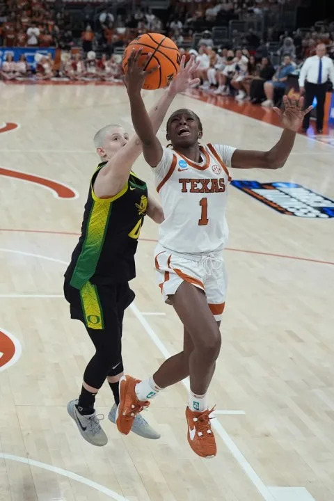 Texas guard Bryanna Preston (1) drives to the basket against Oregon guard Astera Tuhina (0) during the first half in the second round of the NCAA college basketball tournament, Sunday, March 22, 2026, in Austin, Texas. (AP Photo/Eric Gay)
