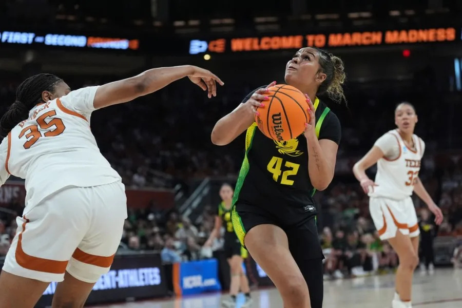 Oregon guard Avary Cain (42) looks to shoot over Texas forward Madison Booker (35) during the first half in the second round of the NCAA college basketball tournament, Sunday, March 22, 2026, in Austin, Texas. (AP Photo/Eric Gay)