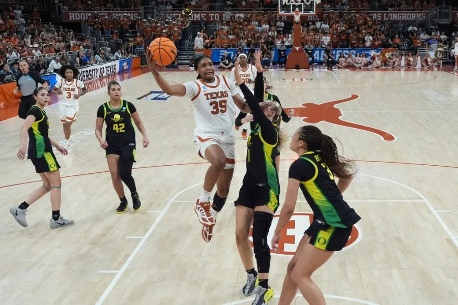 Texas forward Madison Booker (35) drives to the basket against Oregon forward Mia Jacobs (1) during the first half in the second round of the NCAA college basketball tournament, Sunday, March 22, 2026, in Austin, Texas. (AP Photo/Eric Gay)