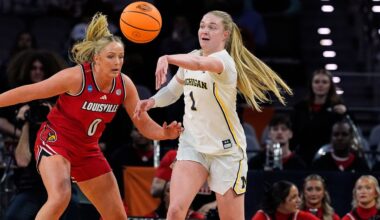 Michigan guard Olivia Olson (1) makes a pass under pressure from Louisville forward Laura Ziegler (0) in the first half in the Sweet 16 of the NCAA college basketball tournament, Saturday, March 28, 2026, in Fort Worth, Texas. (AP Photo/Tony Gutierrez)