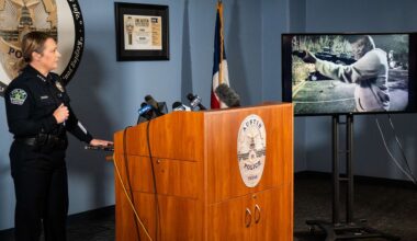 Austin Police Chief Lisa Davis watches footage from a parked vehicle near the scene that shows the suspected gunman during a news conference on Thursday, March 5, 2026 at APD headquarters regarding the release of audio and video footage from Sunday morning's mass shooting on West Sixth Street in Austin. (Sara Diggins/Austin American-Statesman via AP)