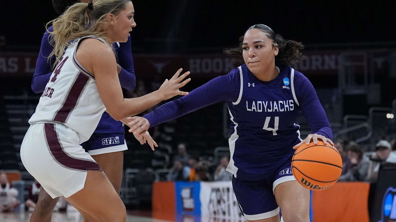 Stephen F. Austin guard Ashlyn Traylor-Walker (4) drives around Missouri State guard Kaemyn Bekemeier (24) during the second half in a First Four college basketball game in the NCAA Tournament, Wednesday, March 18, 20206, in Austin, Texas. (AP Photo/Eric Gay)