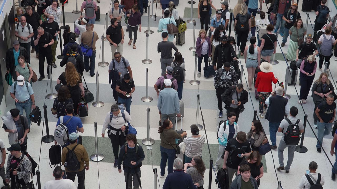 Travelers line up at a TSA checkpoint at George Bush Intercontinental Airport in Houston, Tuesday, March 24, 2026.  (AP Photo/Lekan Oyekanmi)