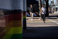 Carol Able-Wright, right, crosses a rainbow painted crosswalk at Cedar Springs Road and...