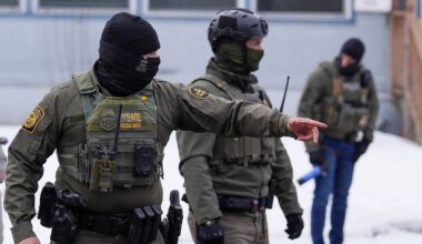A United States Border Patrol agent gestures to a car while conducting immigration enforcement operations, Thursday, Feb. 5, 2026, in Minneapolis. (AP Photo/Ryan Murphy)