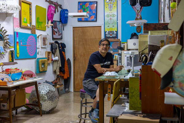 A photograph of artist Andy Benavides in his studio.