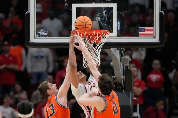 Houston center Chris Cenac Jr. (5) shoots between Illinois center Tomislav Ivišić (13) and forward David Mirković during the second half in the Sweet 16 of the NCAA Tournament on Thursday, March 26, 2026, in Houston. (Ashley Landis/AP)