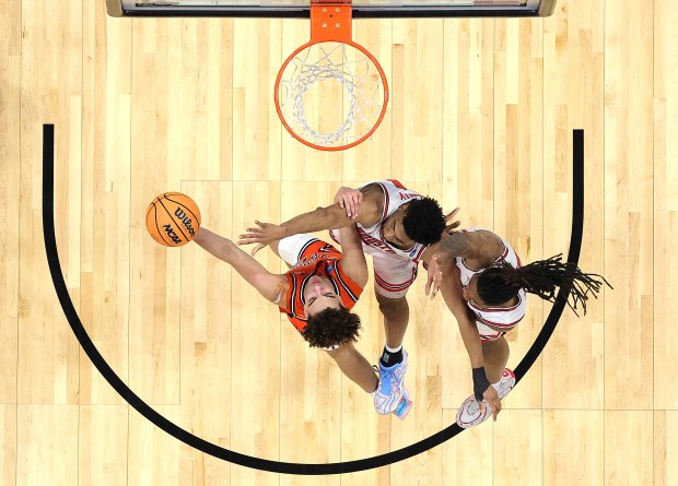 Illinois' Keaton Wagler, left, shoots against Houston's Chase McCarty and Joseph Tugler in the Sweet Sixteen of the NCAA Tournament on Thursday, March 26, 2026, in Houston. (Alex Slitz/Getty)