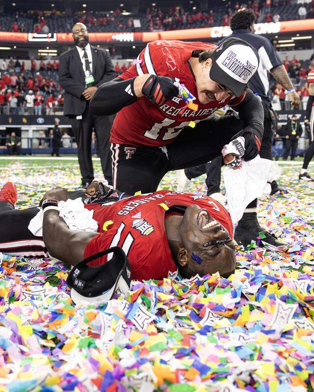 Former Star-Telegram photographer Chris Torres earned Top 10 recognition in the Associated Press Sports Editors contest for this feature photo: Texas Tech linebacker Jacob Rodriguez (10) celebrates with linebacker Bryce Ramirez after winning the Big 12 championship game against BYU on Dec. 6, 2025, at AT&T Stadium in Arlington.