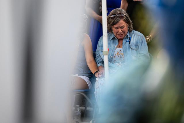 Lisa Randolph, the wife of the late Fort Worth Police Department Sgt. Billy Randolph, becomes emotional during speeches about her husband during his honorary candlelit vigil at the Fort Worth PD South Division headquarters in Fort Worth on Aug. 14, 2024. Sgt. Randolph was struck by a car while working at a crash scene on the exit ramp of I-35W near Sycamore School Road.