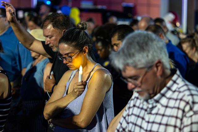 Community members join in prayer for the late Fort Worth Police Department Sgt. Billy Randolph during his honorary candlelit vigil at the Fort Worth PD South Division headquarters on Aug. 14, 2024. Sgt. Randolph was struck by a car while working a crash scene on the exit ramp of I-35W near Sycamore School Road.