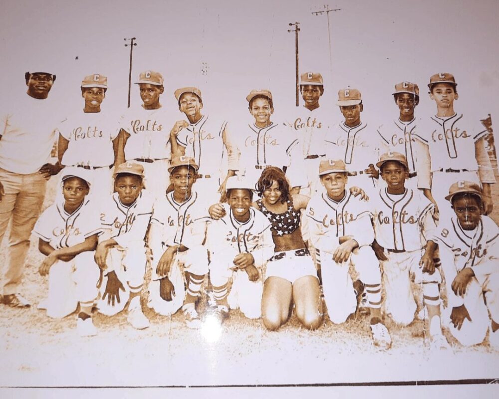 Coach James Robert Hall, left, stands with the Tuffly Park Colts baseball team in the late 1960s.