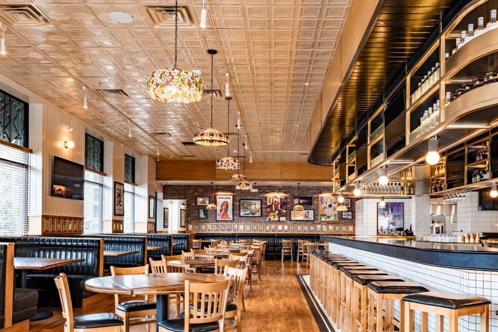 A photo of the interior of DL Mack's at the West Village including tables and part of the bar. 