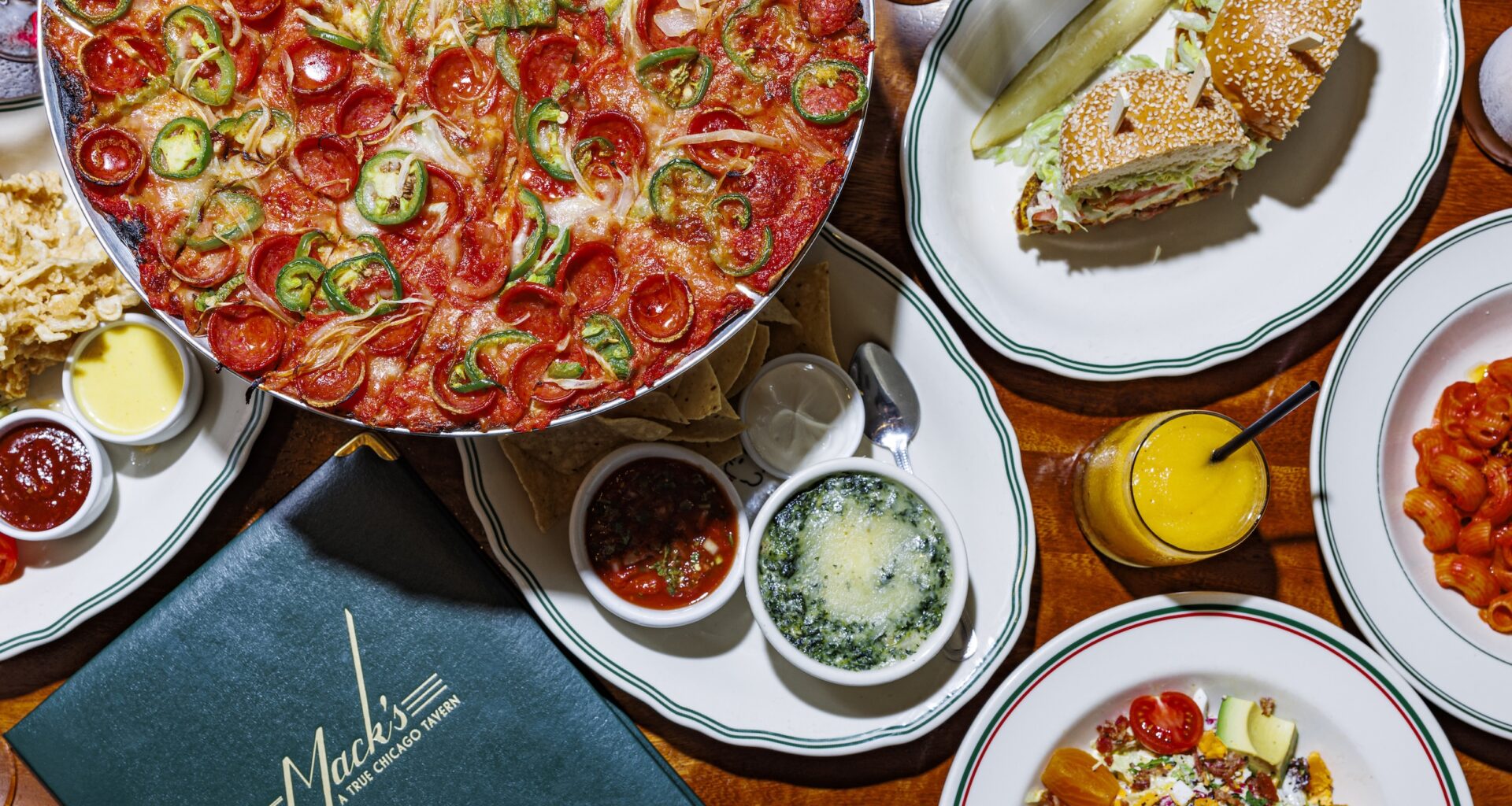 A table at DL Mack's full of some of their signature men items including a sandwich and pizza.
