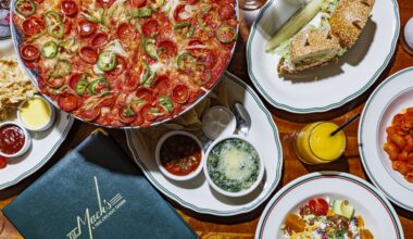 A table at DL Mack's full of some of their signature men items including a sandwich and pizza.