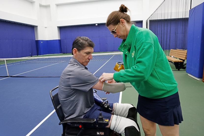 Victoria Rosas helps her husband Ron Rosas, a University Park resident and a quadriplegic,...