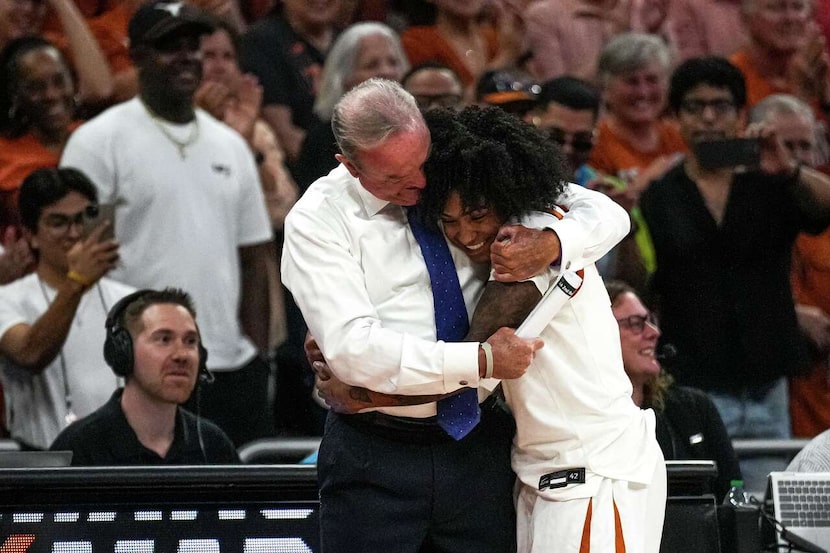Texas Longhorns head coach Vic Schaefer hugs gaurd Rori Harmon (3) as she exits the second...