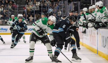 Dallas Stars left wing Jason Robertson, center left, fights for the puck against Utah Mammoth defenseman John Marino (6) during the second period of an NHL hockey game, Thursday, Jan. 15, 2026, in Salt Lake City. (AP Photo/Melissa Majchrzak)