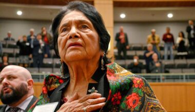 Dolores Huerta, the Mexican-American social activist who formed a farm workers union with Cesar Chavez, stands for the Pledge of Allegiance in Spanish while visiting the New Mexico Statehouse in Santa Fe. N.M., on Feb. 27, 2019. (AP Photo/Russell Contreras)