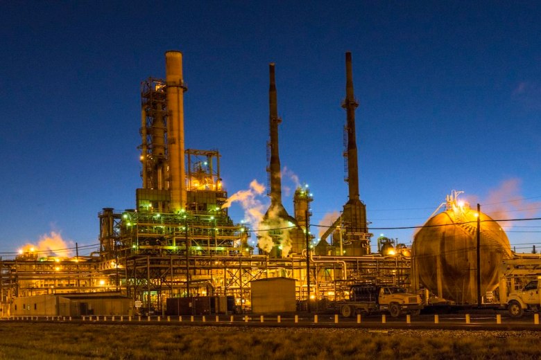 A photo shows Valero's Port Arthur refinery at dusk.