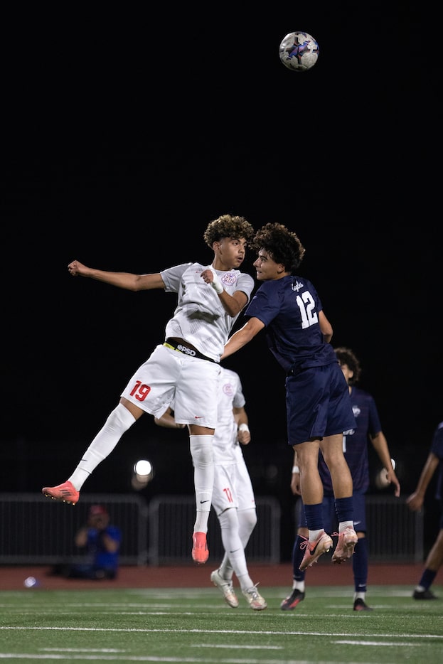 Arlington Sam Houston Boys SoccerÕs Sjhanny Sanchez (19) and AllenÕs Joao Nunes (12), right...
