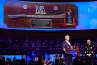 First Baptist Dallas Sr. Exec. Pastor Ben Lovvorn (left) holds a ceremonial plaque that was...
