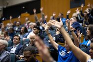 Members of the audience show support to a speaker who spoke in favor of keeping Dallas City...