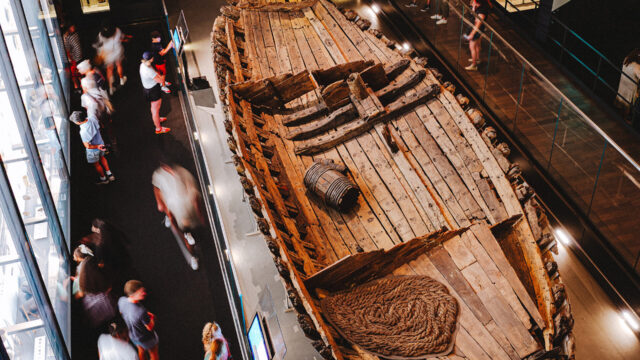 Aerial view of a ship’s hull that has barrels and rope inside.