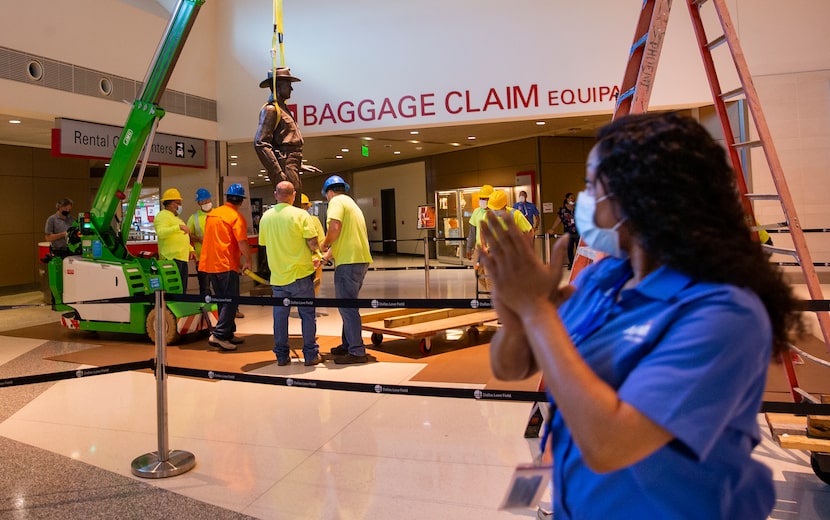 Tiffany Anderson clapped as a Phoenix 1 Restoration & Construction crew removes the "One...