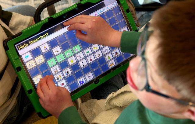 Luke Lunday, 12, uses an augmentative and alternative communication device to talk about how he feels about a Texas lawsuit that is threatening to take away services he needs to live at home on Friday, March 13, 2026, in Trophy Club. Luke was born with a rare genetic syndrome.