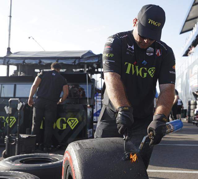 A crew member for Will Power (26) works on tires for the inaugural Java House Grand Prix of Arlington in Arlington, Texas, Sunday, March, 15, 2026.