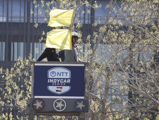 Race officials post the yellow flag after a driver hit a wall during the inaugural Java House Grand Prix of Arlington in Arlington, Texas, Sunday, March, 15, 2026.
