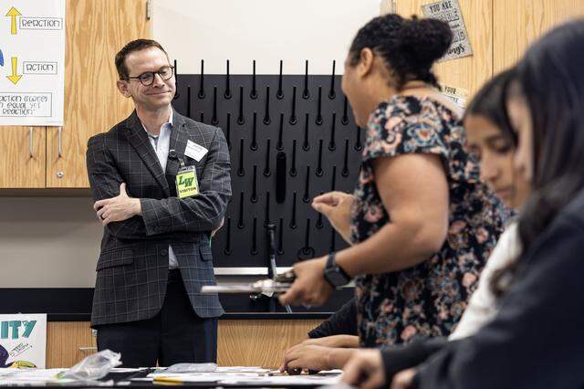 Mike Morath, the Texas Commissioner of Education, looks over the work of a student in a science class at Lucyle Collins Middle School in Lake Worth on Tuesday, Oct. 21, 2025.