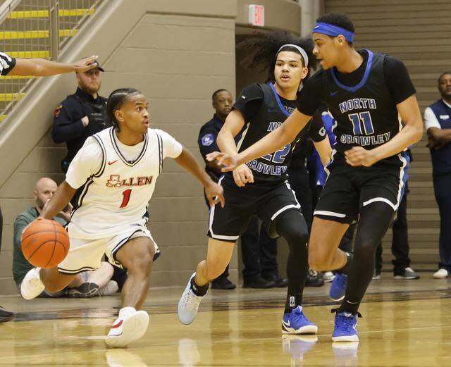 North Crowley guard Isaak Hayes (22) and wing Trey Hall (11) box in Allen's Nehemiah Lawrence (1) during the first half of a UIL Class 6A Division I boys regional final basketball game at Thomas Coliseum in Haltom City, Texas, Friday, Mar. 06, 2026.
