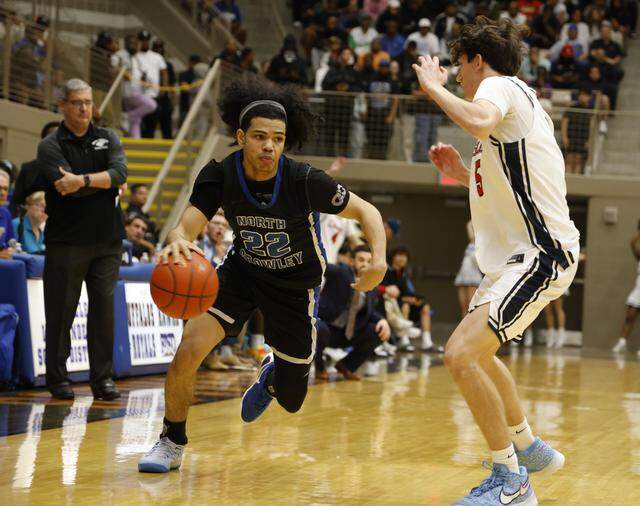 North Crowley guard Isaak Hayes (22) drives to the corner against Allen's Austin Lowenberg (5) during the second half of a UIL Class 6A Division I boys regional final basketball game at Thomas Coliseum in Haltom City, Texas, Friday, Mar. 06, 2026.