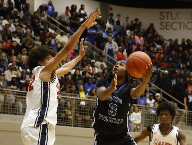 North Crowley guard Dontre Grandberry (3) left hooks one over the Allen defense during the first half of a UIL Class 6A Division I boys regional final basketball game at Thomas Coliseum in Haltom City, Texas, Friday, Mar. 06, 2026.