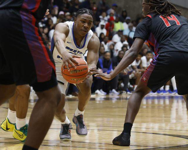 North Crowley guard Kameron Price (2) almost loses the ball between Duncanville guard Jirehn Mitchell and forward Jairus Ingram (14) during the first half of a UIL Class 6A Division I boys semifinal basketball game at Wilkerson Greines Activity Center in Fort Worth, Texas, on Tuesday, March 10, 2026.