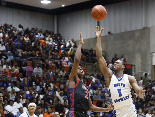 North Crowley forward Alex Barther (1) shoots over Duncanville guard Jirehn Mitchell (3) during the first half of a UIL Class 6A Division I boys semifinal basketball game at Wilkerson Greines Activity Center in Fort Worth, Texas, Monday, Mar. 10, 2026.
