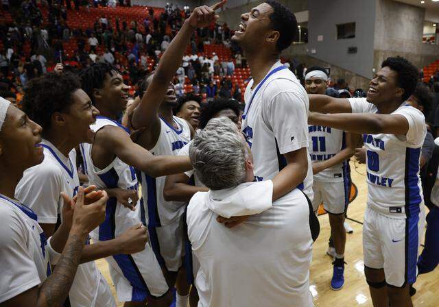 Teammates lift North Crowley guard Tyler Hastings (15) after he scored the winning bucket, defeating Duncanville in a UIL Class 6A Division I boys semifinal basketball game at Wilkerson-Greines Activity Center in Fort Worth, Texas, Monday, March 10, 2026.
