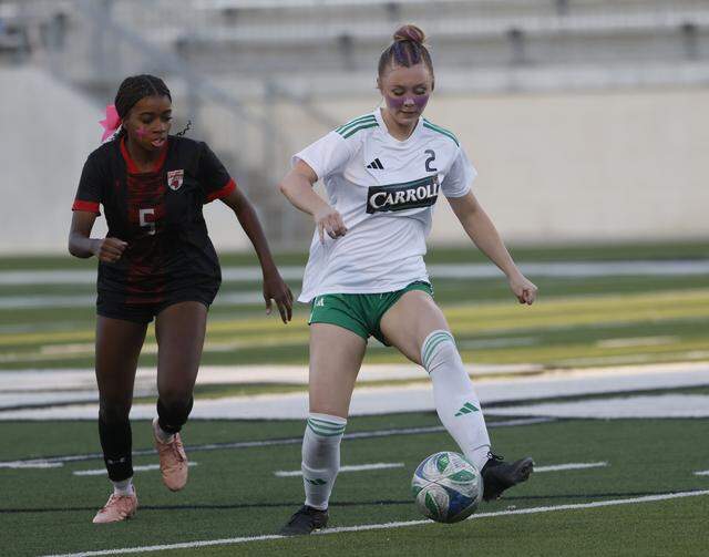 Southlake Carroll midfielder Macie Colvin drives the ball ahead of Mansfield Legacy forward Daisy Carew during the second half of a UIL bi-district round soccer playoff game at Crowley ISD Multi-Purpose Stadium in Fort Worth, Texas, on Friday, March 20, 2026.