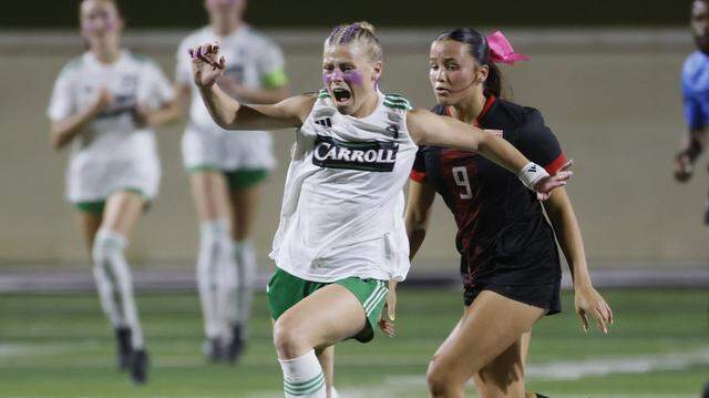Southlake Carroll forward Caroline Holcombe (9) brings the ball down the pitch ahead of Mansfield Legacy defender Bella Baker (9) during the second half of a UIL bi-district round soccer playoff game at Crowley ISD Multi-Purpose Stadium in Fort Worth, Texas, Friday, March, 20, 2026.