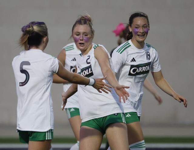 Southlake Carroll midfielder Macie Colvin, midfielder Audrey Anderson (5) and forward Tori Stovall celebrate after Anderson scored during the second half of a UIL bi-district round soccer playoff game at Crowley ISD Multi-Purpose Stadium in Fort Worth, Texas, on Friday, March 20, 2026.