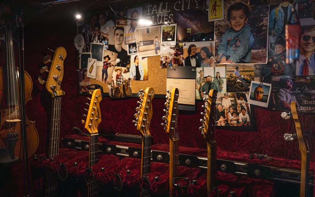A case of the band's guitars lined with personal photos backstage on October 10, 2025.
