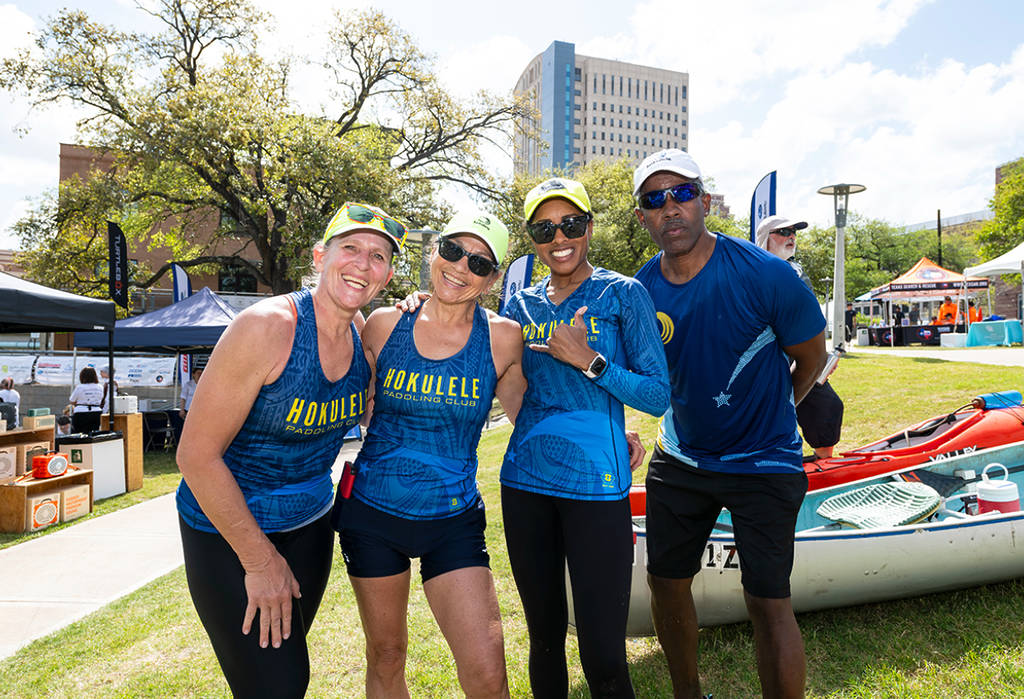 Image shows a team of participants posing for a photo in honor of the Buffalo Bayou Partnership Regatta in Houston. 